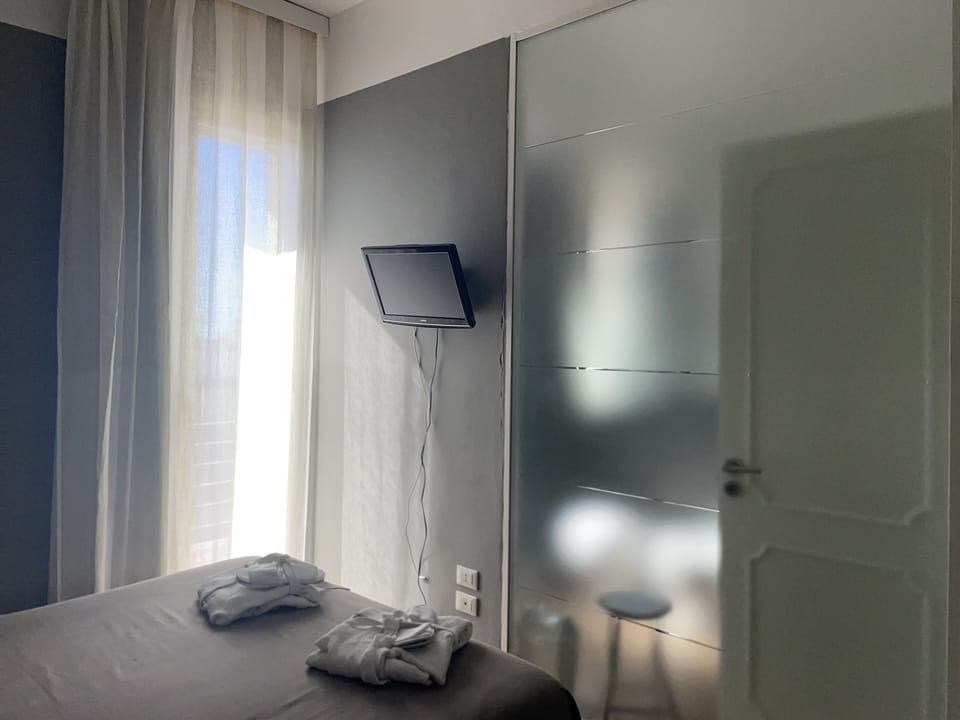 Double Room, Balcony, Partial Sea View | Minibar, in-room safe, individually decorated, individually furnished