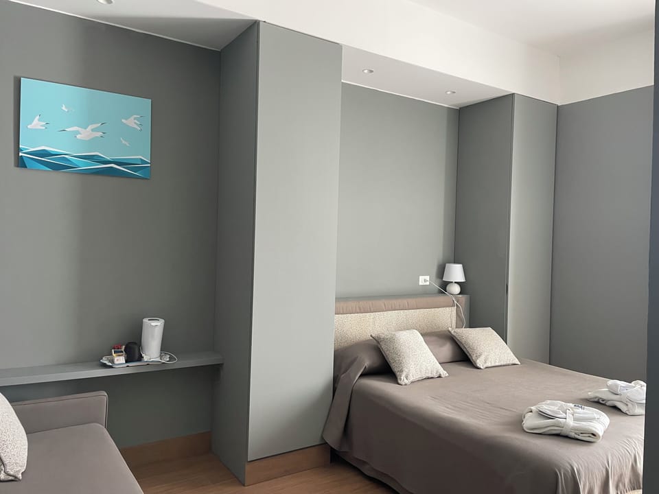Double Room, Balcony, Partial Sea View | Minibar, in-room safe, individually decorated, individually furnished