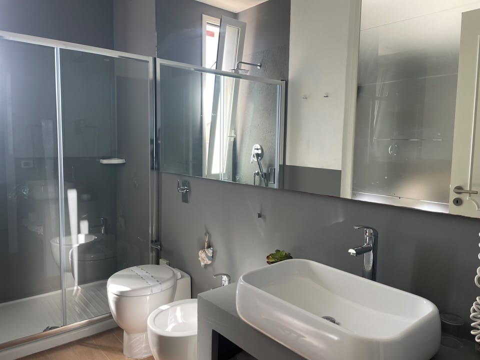 Double Room, Balcony, Partial Sea View | Bathroom | Shower, rainfall showerhead, free toiletries, hair dryer