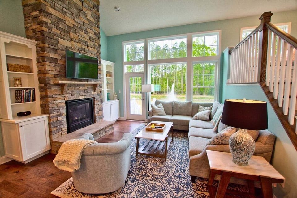 Your Family Room on Main Floor w Sloped Ceilings and View of Pond and Woods