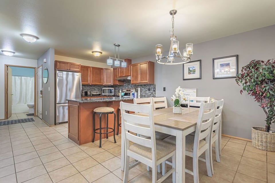 Open floor plan living, dining, kitchen opens up to the back grassy area.