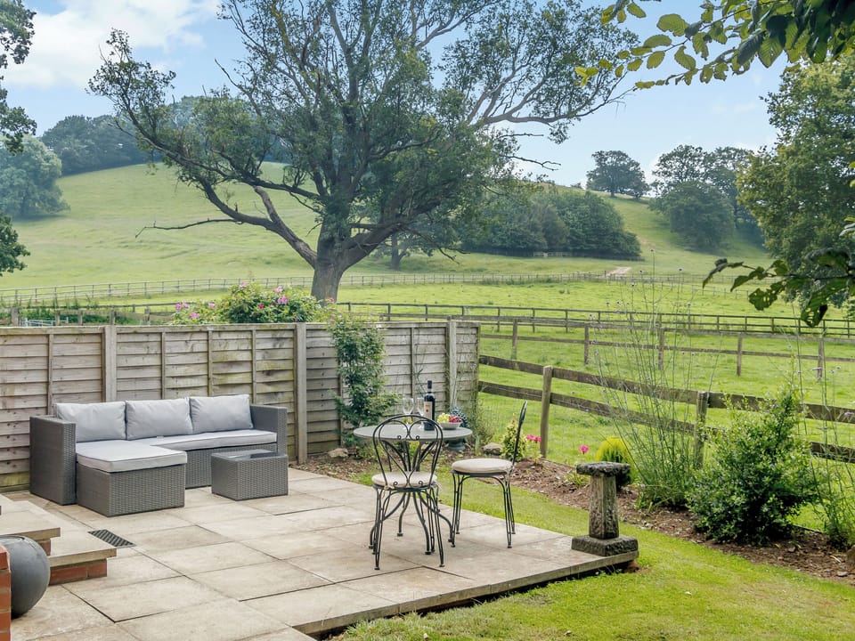 Paved patio with a range of garden furniture | The Bothy - Netherley Hall Cottages, Mathon, near Malvern