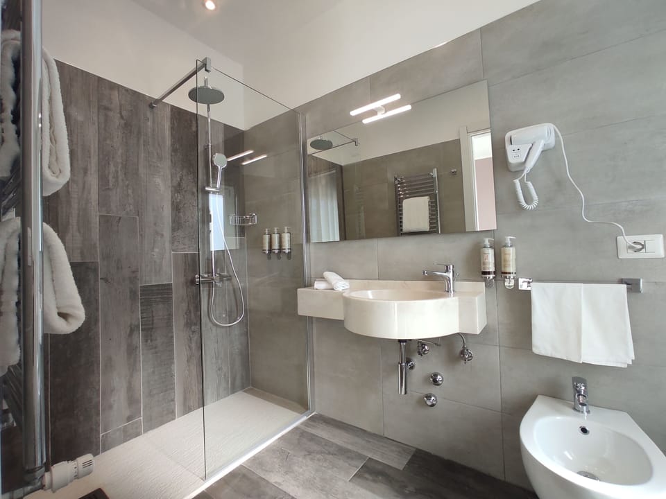 Family Room | Bathroom | Rainfall showerhead, eco-friendly toiletries, hair dryer, bathrobes