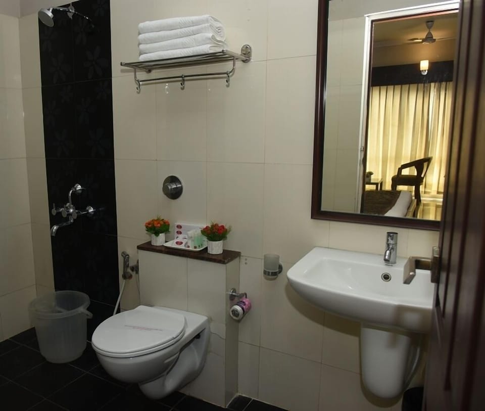 Suite, 1 King Bed | Bathroom | Shower, rainfall showerhead, free toiletries, slippers