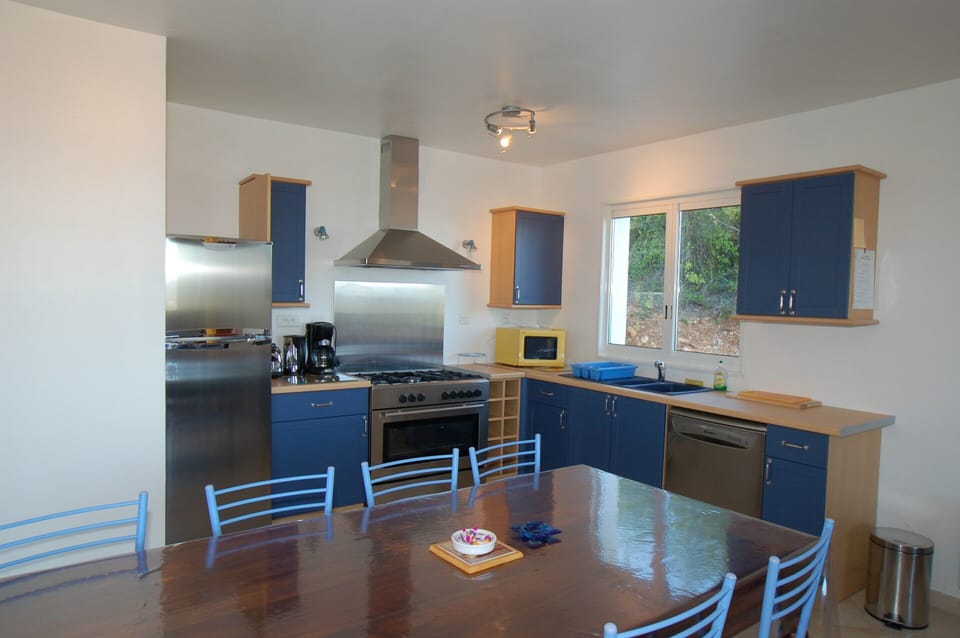 Villa | Private kitchen | Fridge, highchair