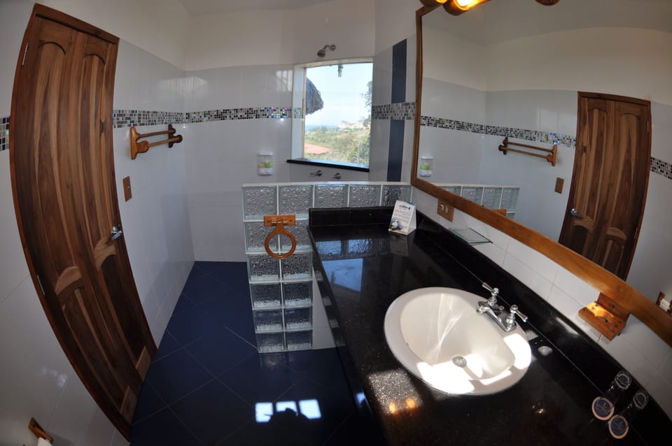 Luxury Cabin | Bathroom | Shower, rainfall showerhead, towels, soap