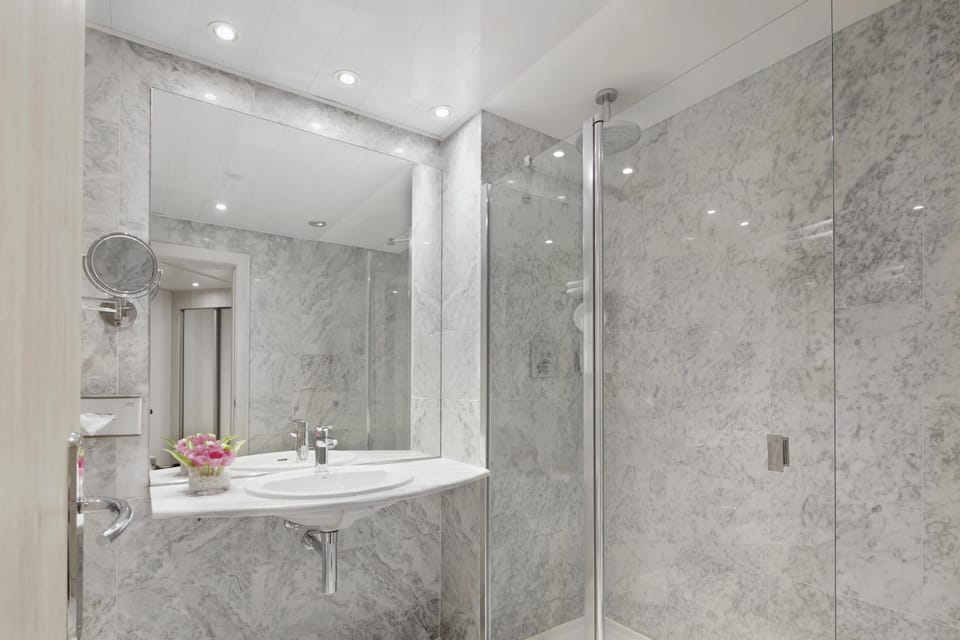 Deep soaking tub, rainfall showerhead, eco-friendly toiletries