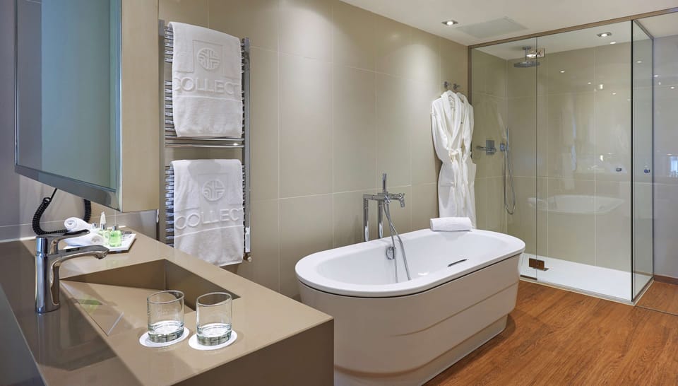 Deep soaking tub, rainfall showerhead, eco-friendly toiletries