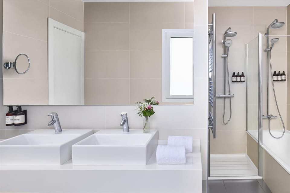 Shower, designer toiletries, hair dryer, towels