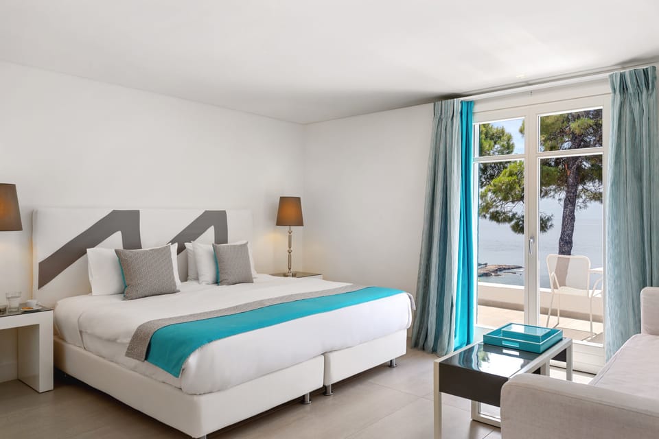 Junior Suite, Sea View | Memory foam beds, minibar, in-room safe, desk