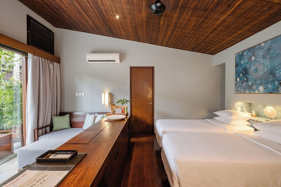 Komune Suites | Living area | 32-inch LCD TV with satellite channels, TV