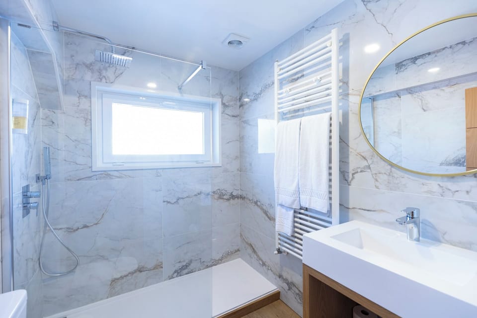 Bathtub, designer toiletries, hair dryer, bidet