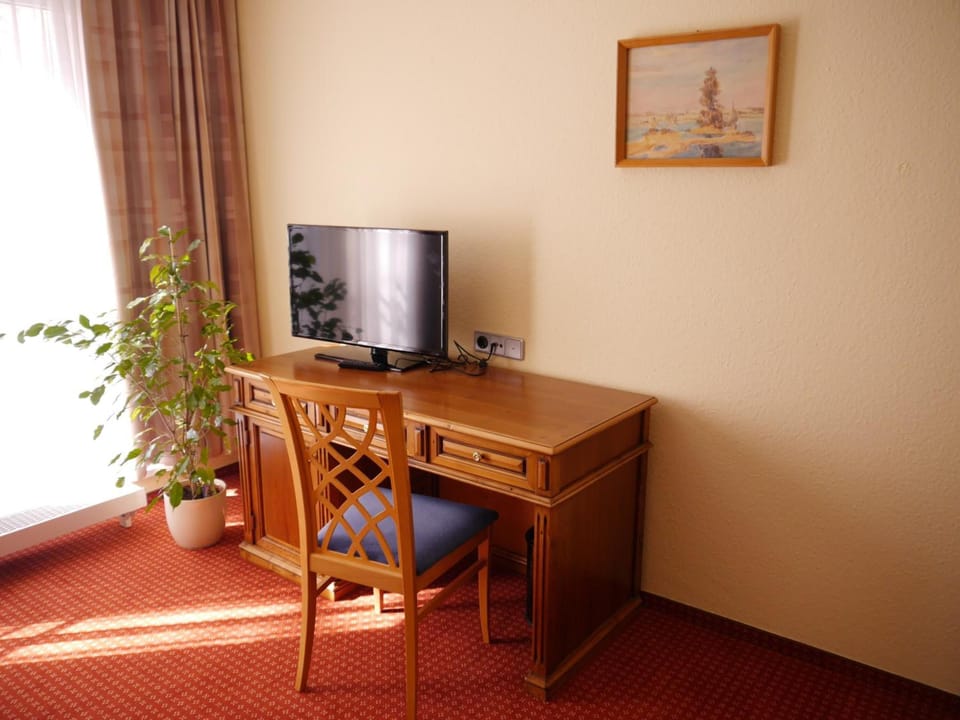 Desk, iron/ironing board, bed sheets