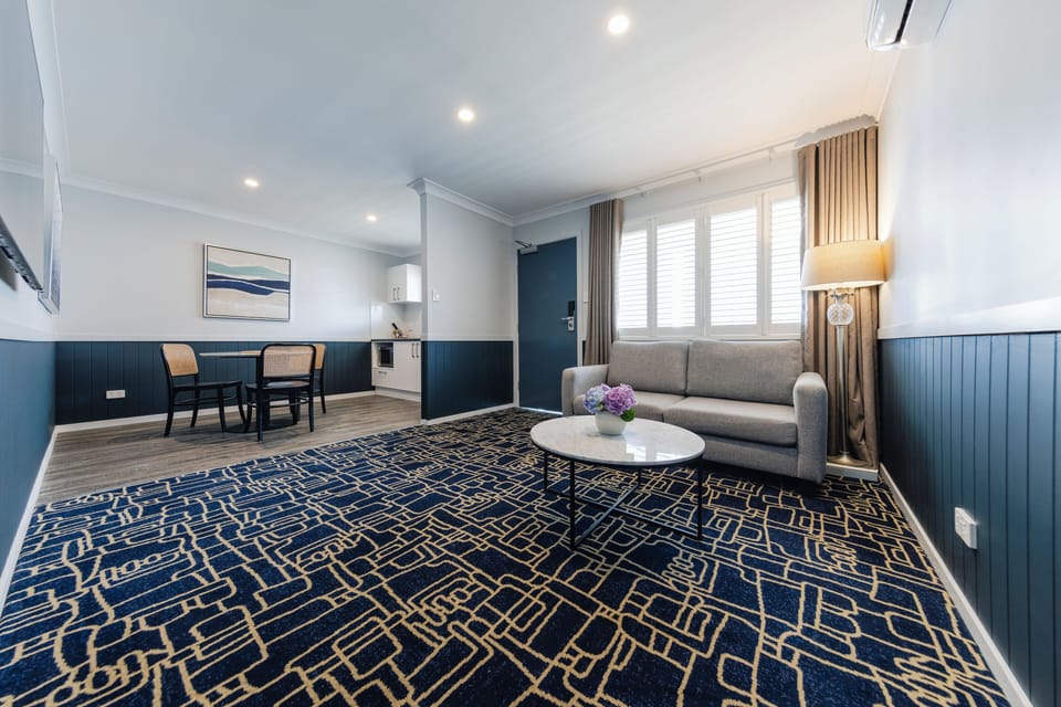 Deluxe 1 Bedroom Apartment | Living area | 50-inch TV with cable channels, Netflix, streaming services