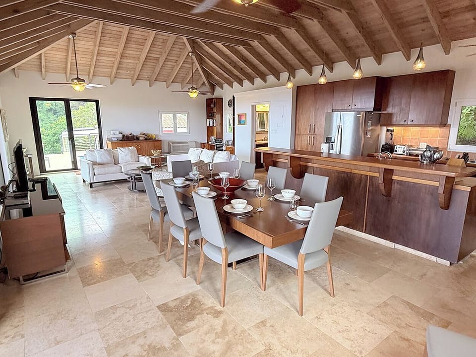 The dining area opens into the cozy living room at Summerwind.