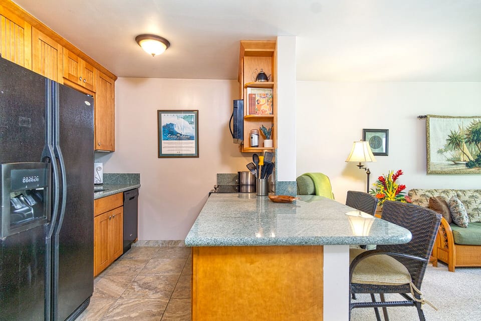 Tastefully updated kitchen with modern appliances and island-inspired décor — perfect for preparing meals.