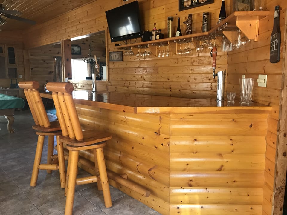 Bar and pool table are off the kitchen with fire pit & deck outside sliding door
