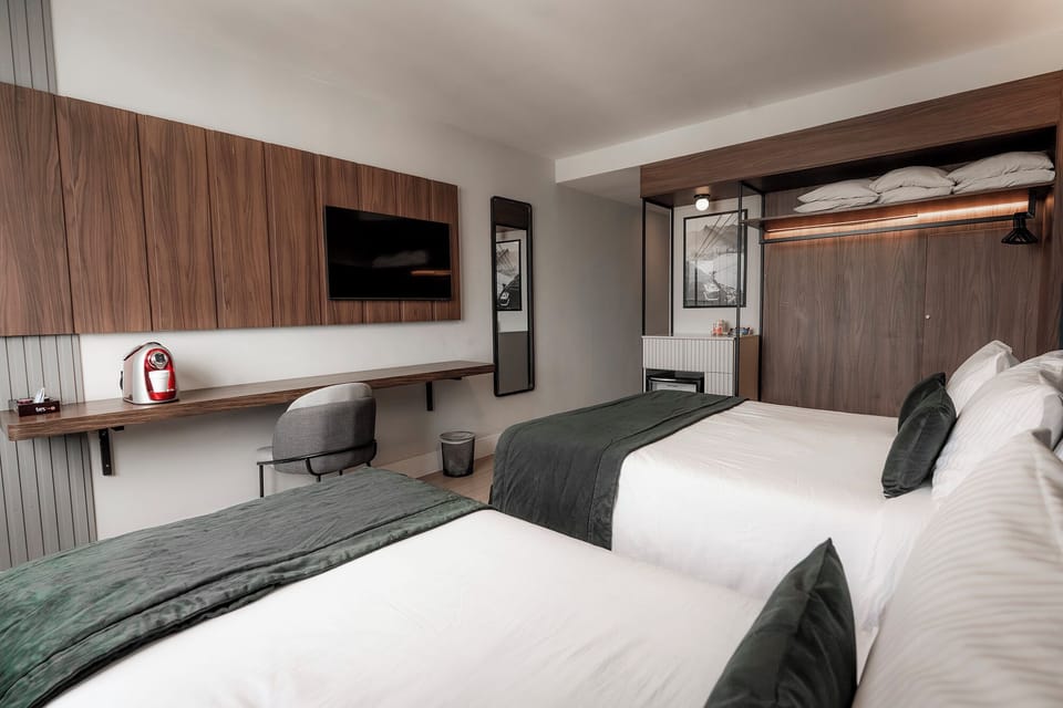 Deluxe Triple Room | Minibar, in-room safe, desk, laptop workspace
