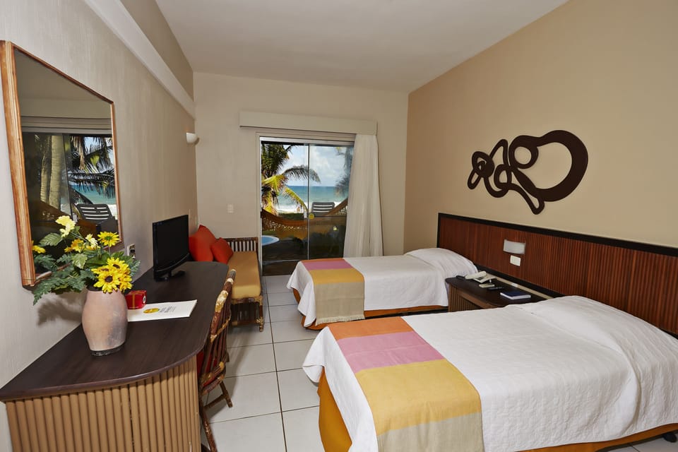 Deluxe Apartment, Beach View | Minibar, desk, free WiFi, bed sheets
