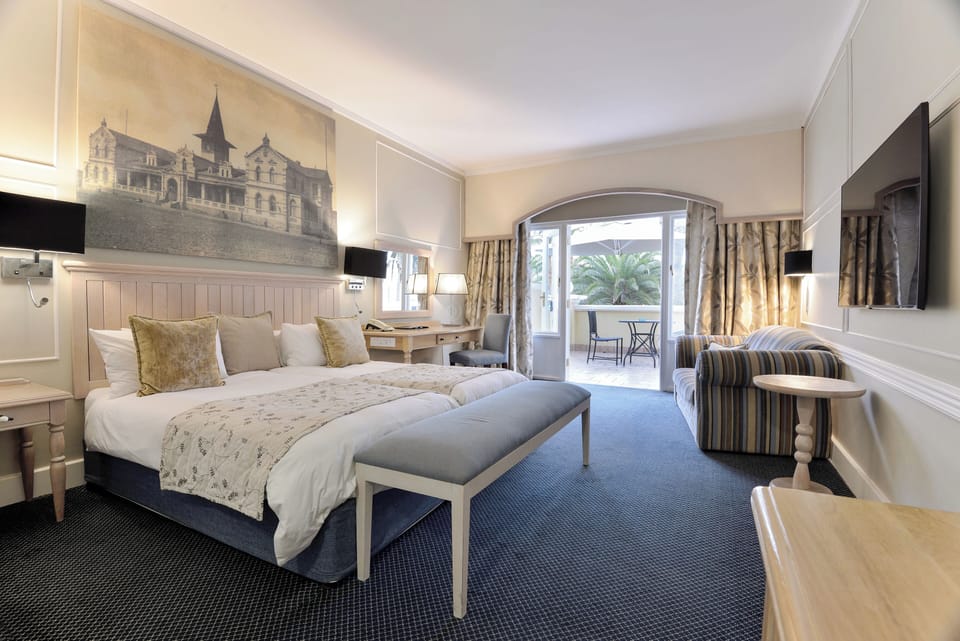 Standard Double Room | Minibar, in-room safe, desk, blackout drapes