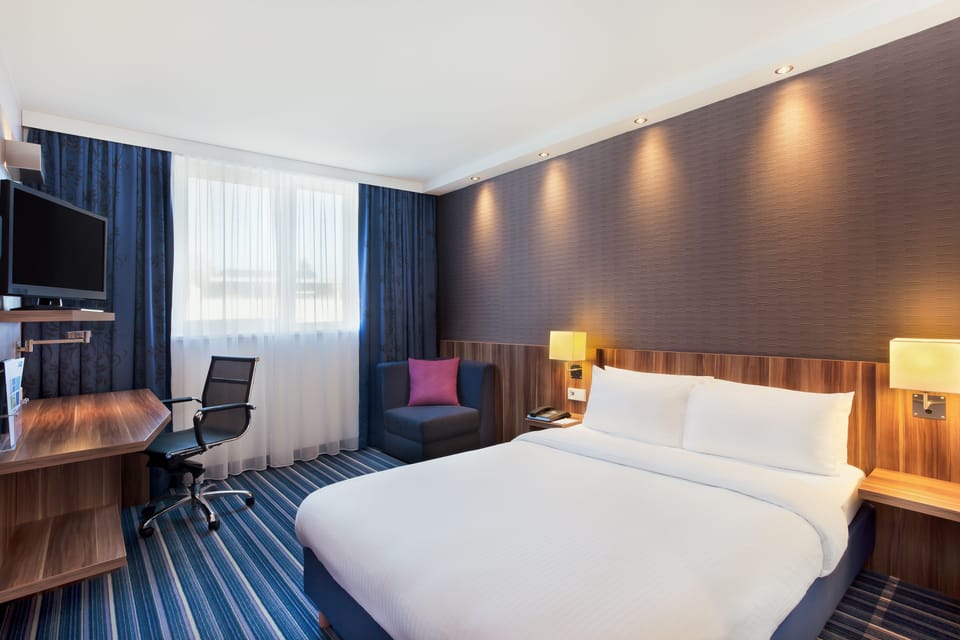 Hypo-allergenic bedding, desk, laptop workspace, blackout drapes