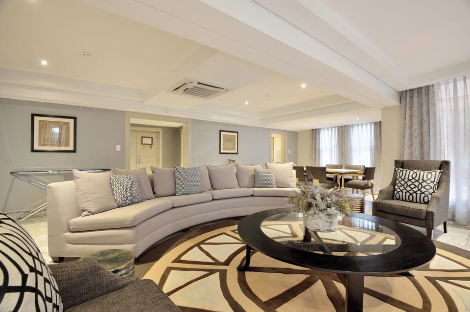 Luxury King Suite | Living area | 40-inch flat-screen TV with satellite channels, TV, pay movies