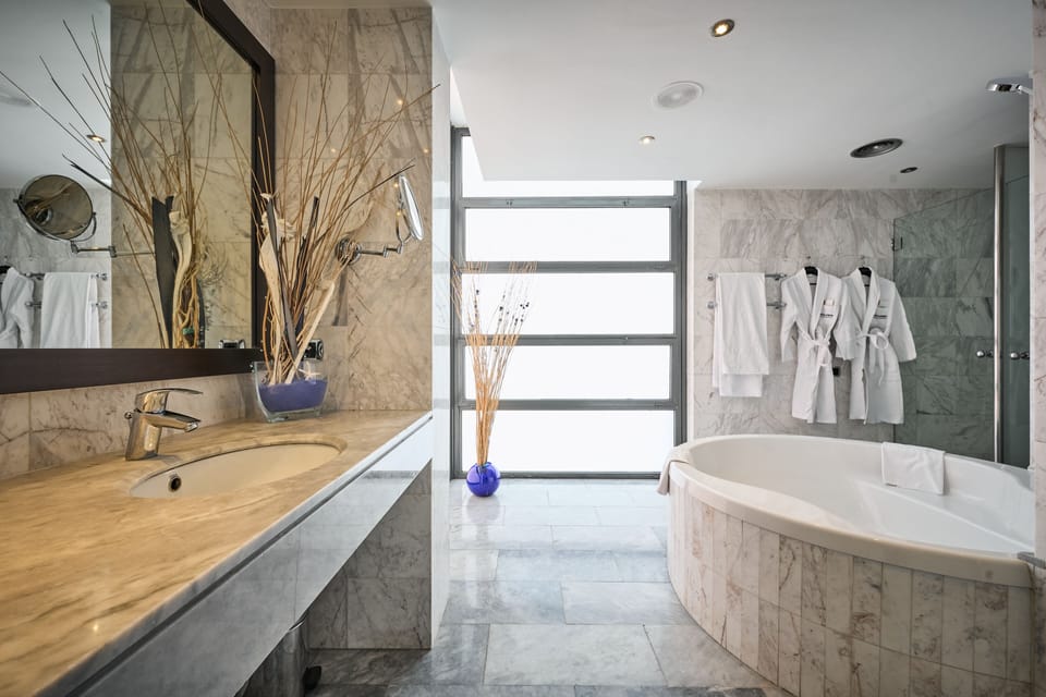 Bathtub, eco-friendly toiletries, hair dryer, towels