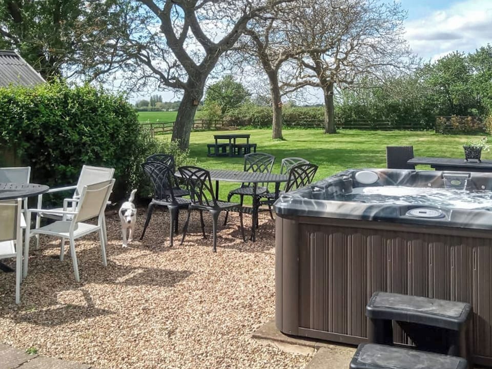 Hot tub and sitting area outside the bar/games room in the paddock 30 metres from the house | Walnut Tree House, Tilney St Lawrence, near Kings Lynn