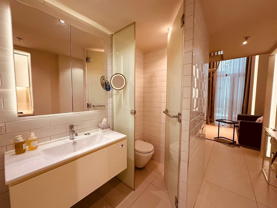 Shower, rainfall showerhead, slippers, towels