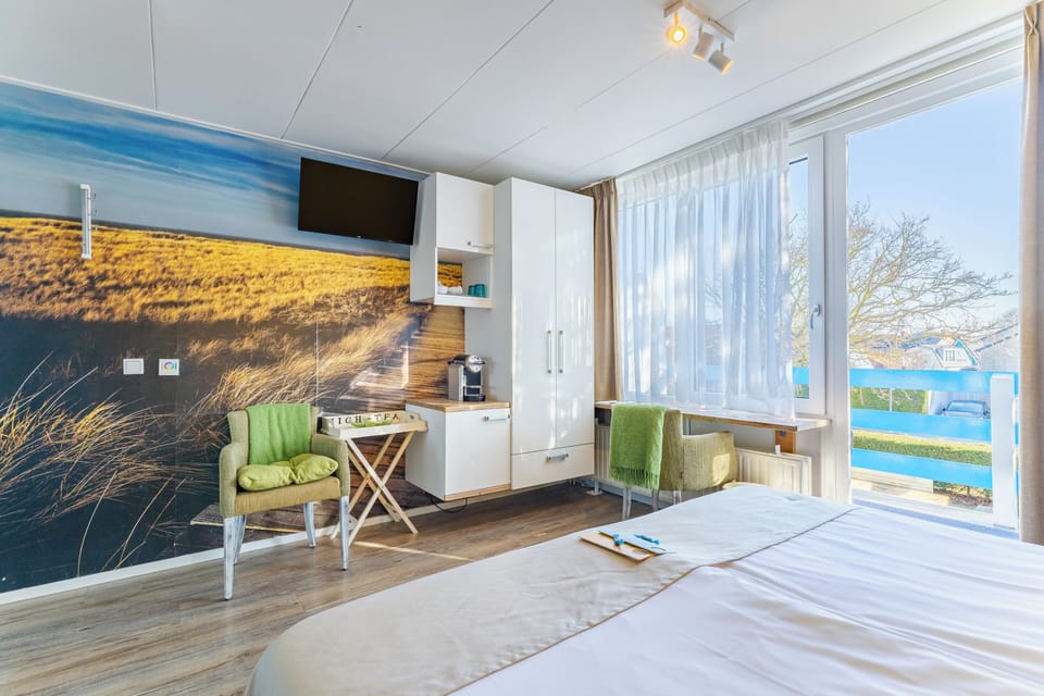 Double Room | Minibar, in-room safe, blackout drapes, iron/ironing board