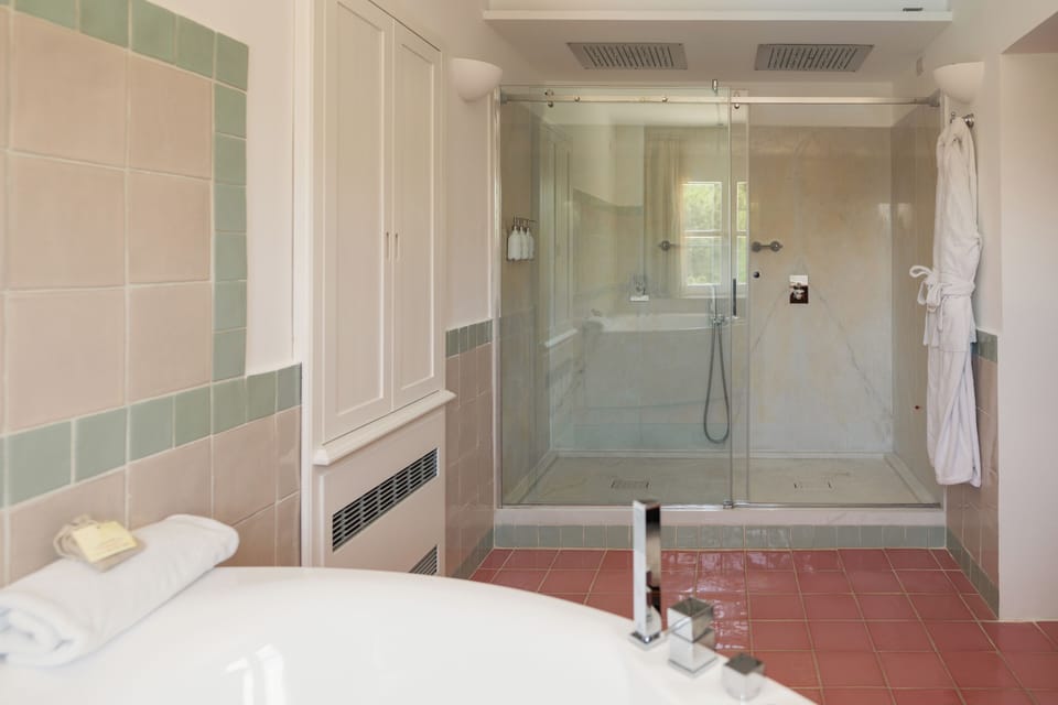 Signature Suite | Bathroom | Designer toiletries, hair dryer, bathrobes, slippers