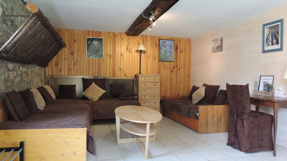 Standard Quadruple Room | Living area | 35-inch flat-screen TV with cable channels, TV