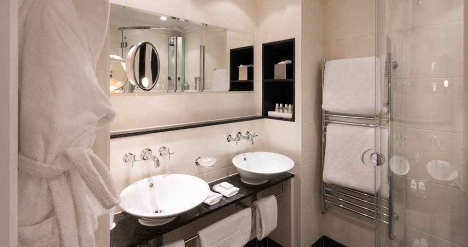 Shower, designer toiletries, hair dryer, bathrobes