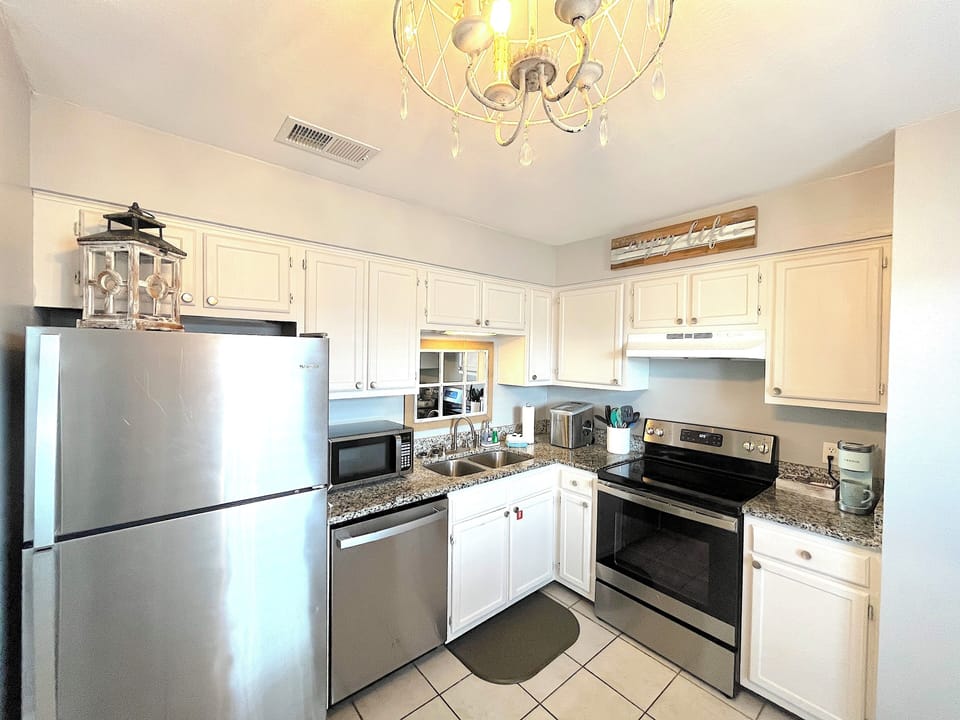 Bright, fully stocked kitchen with everything needed for home-cooked meals.