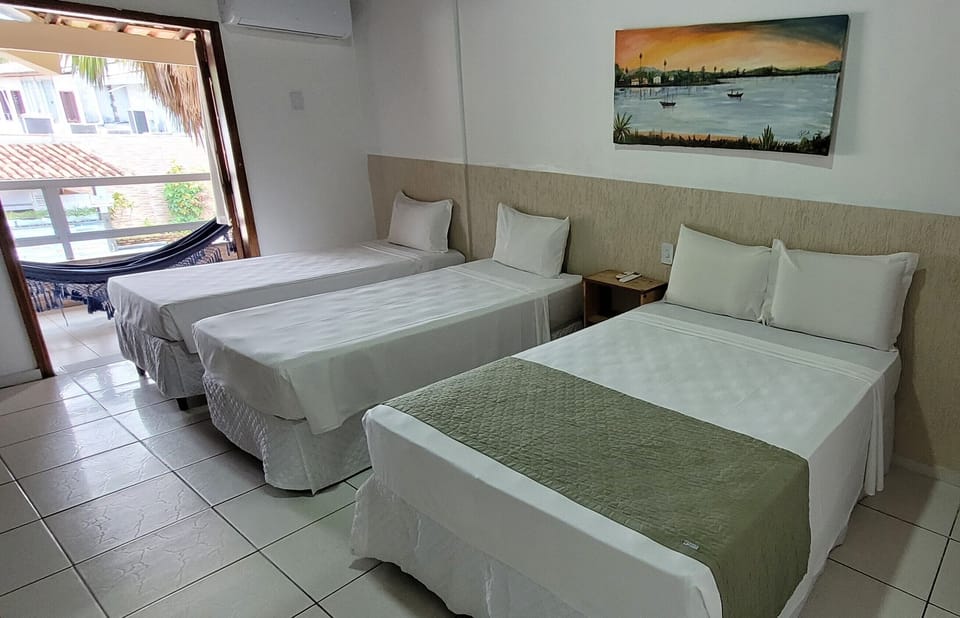 Standard Quadruple Room, Balcony, Pool View | Minibar, desk, laptop workspace, free WiFi