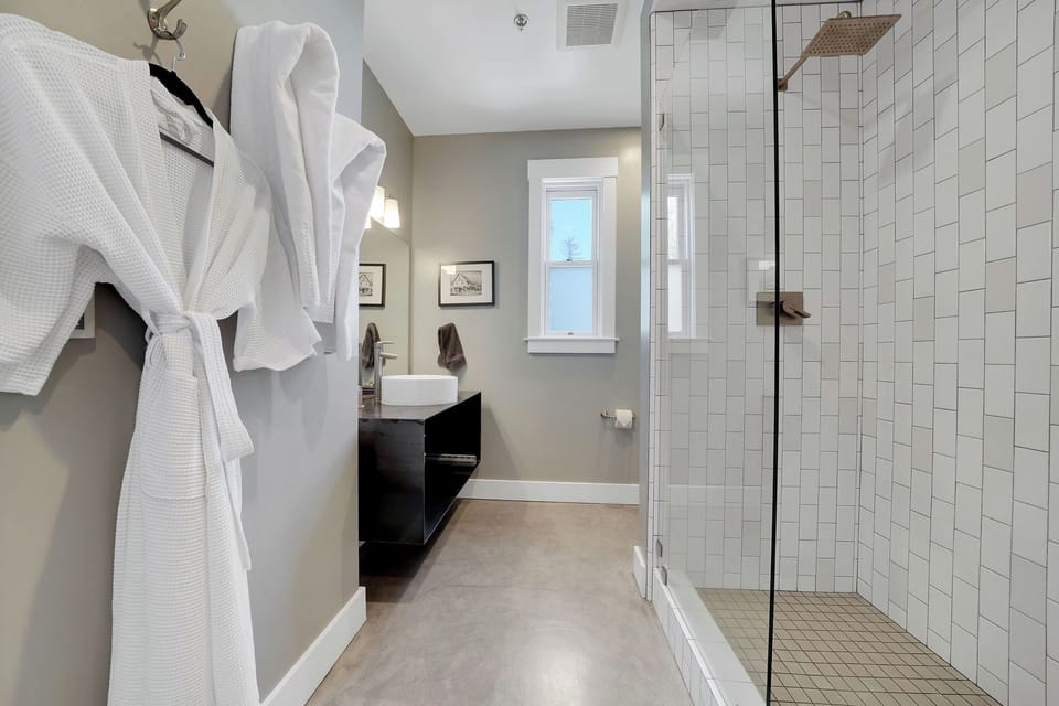 Bathtub, designer toiletries, bathrobes, towels