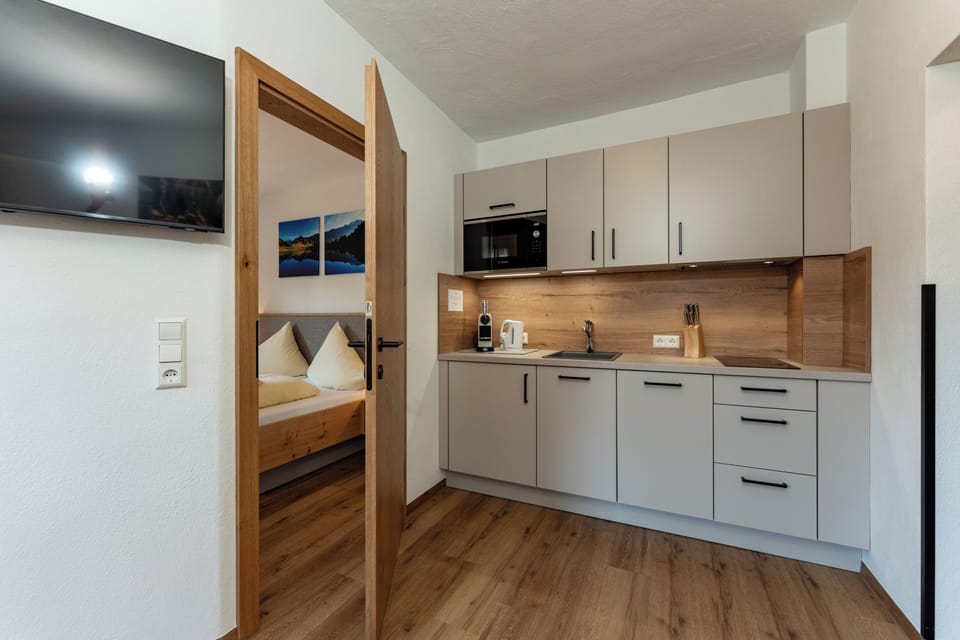 Comfort Suite, Balcony | Living area | 55-inch flat-screen TV with satellite channels, TV, toys