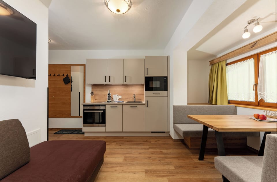 Comfort Suite, 1 Bedroom, Balcony | Living area | 55-inch flat-screen TV with satellite channels, TV, toys