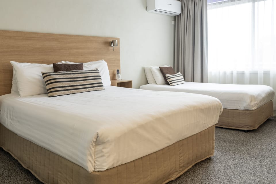 Deluxe Twin Room | Down comforters, Select Comfort beds, desk, iron/ironing board
