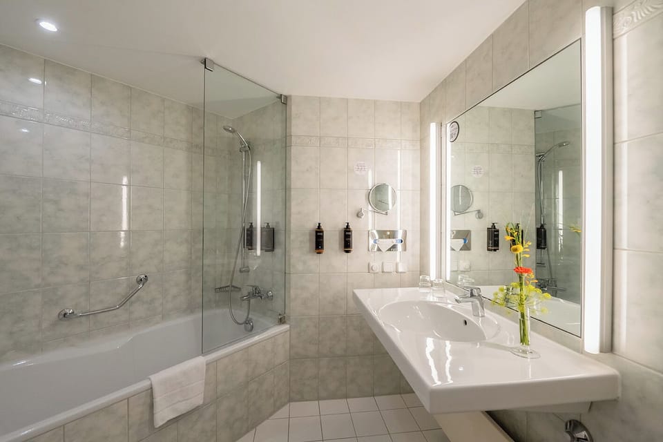Bathtub, eco-friendly toiletries, hair dryer, towels