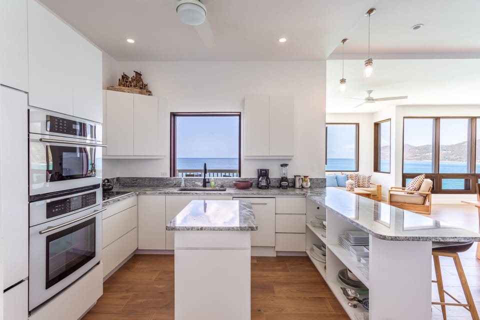 Granite countertops & a simple layout leave the kitchen uncluttered & inviting