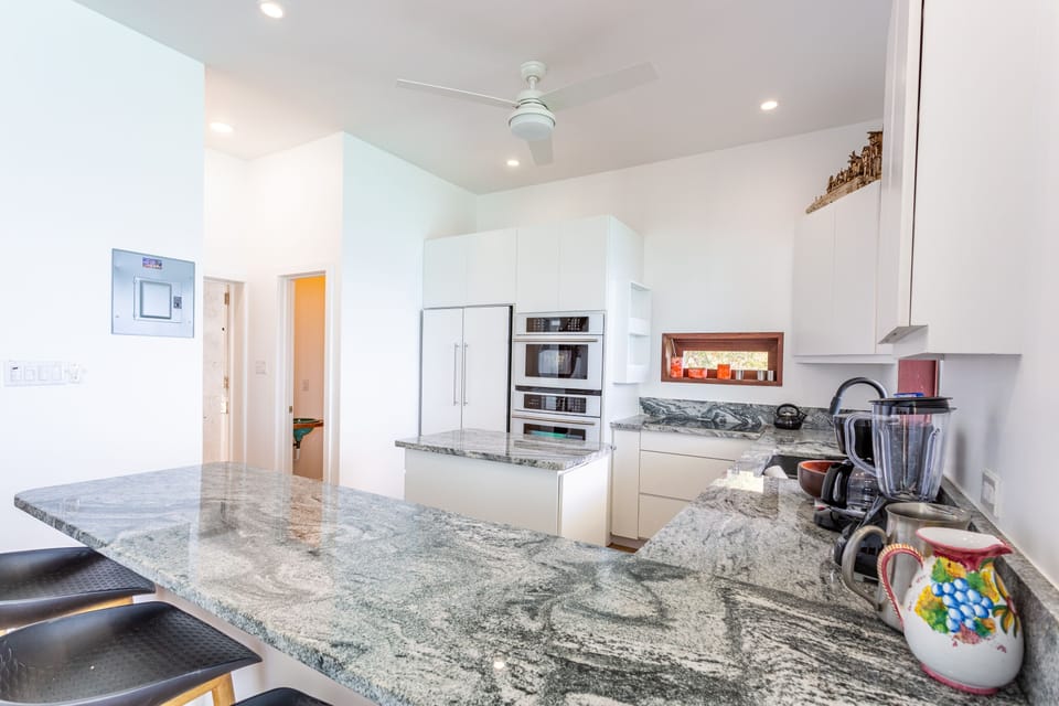 The sleek white kitchen is perfect for your wildest Caribbean concoctions