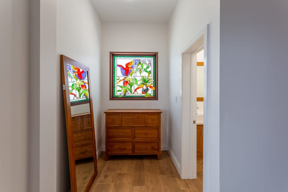 BEDROOM 1: Custom stained glass in the King suite, main floor
