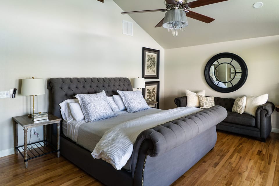 One of the master suites up stairs with king bed and couch for relaxing 
