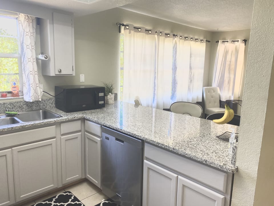 Open format kitchen with breakfast bar seating for 4