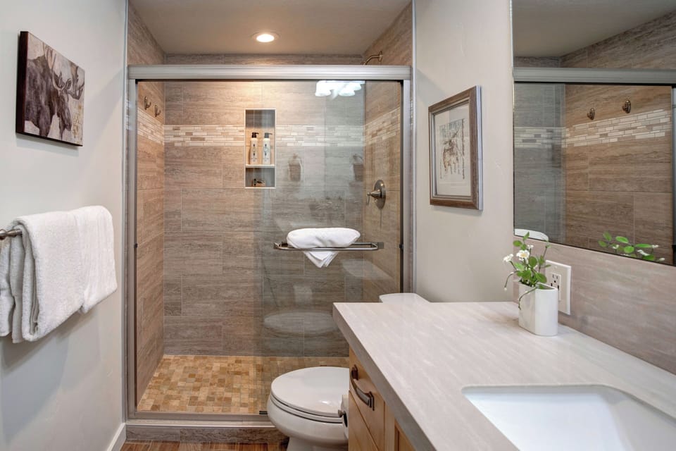 Unwind in your beautifully appointed bathroom featuring a spacious walk-in shower with premium tile work and modern fixtures for your comfort.
