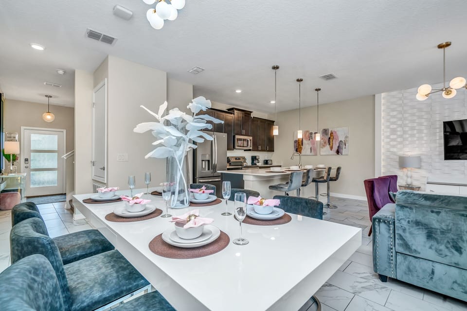 Spacious Townhouse in Kissimmee Florida - Open layout seamlessly connecting the dining area to the kitchen and living area - Luxurious decor for a lavish ambiance - Plush and comfortable seating arrangements