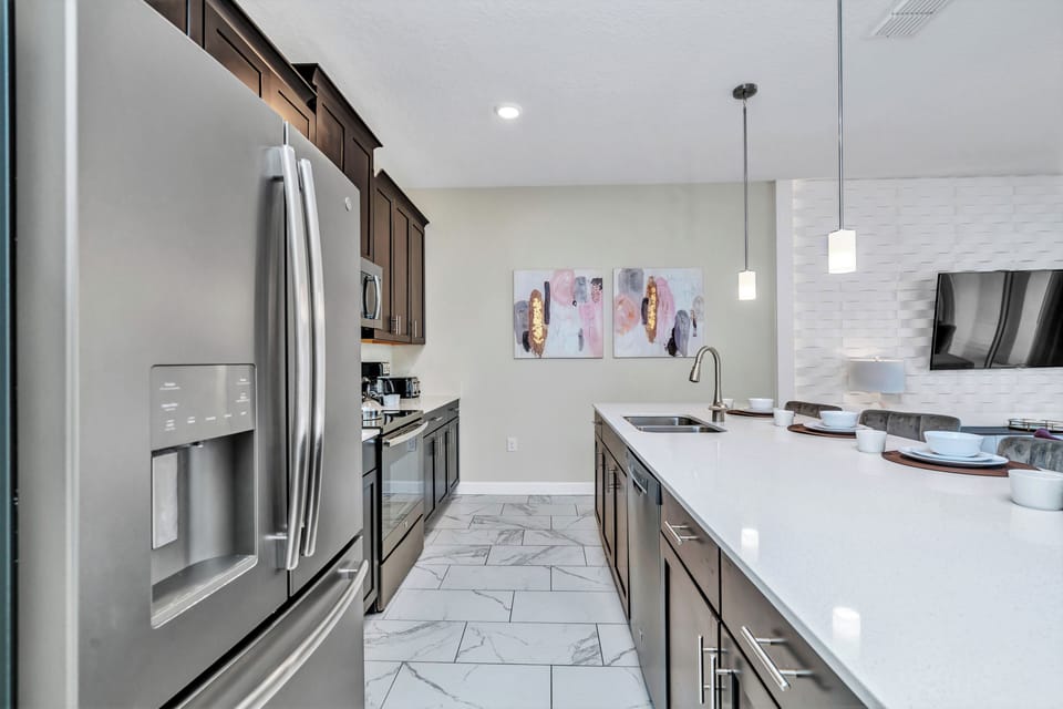 Sleek Kitchen of the Townhouse in Kissimmee Florida - Smart use of space with versatile storage solutions - Functional layout designed for efficient meal preparation - Stainless steel appliances