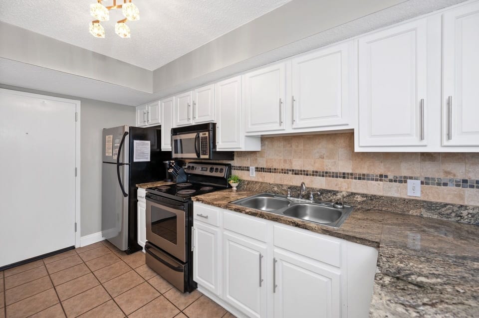 Full Size Kitchen with Granite Countertops and Stainless Steel Appliances