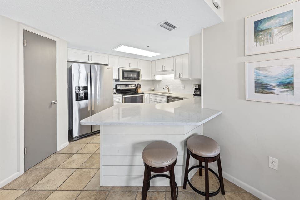Beautifully Updated Kitchen with Stone Countertops and Stainless Steel Appliances